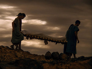 Joseph and Nicodemus carry Jesus to a tomb to bury Him