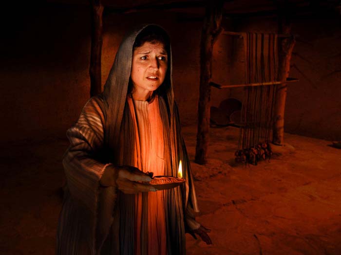 woman searching with a candle